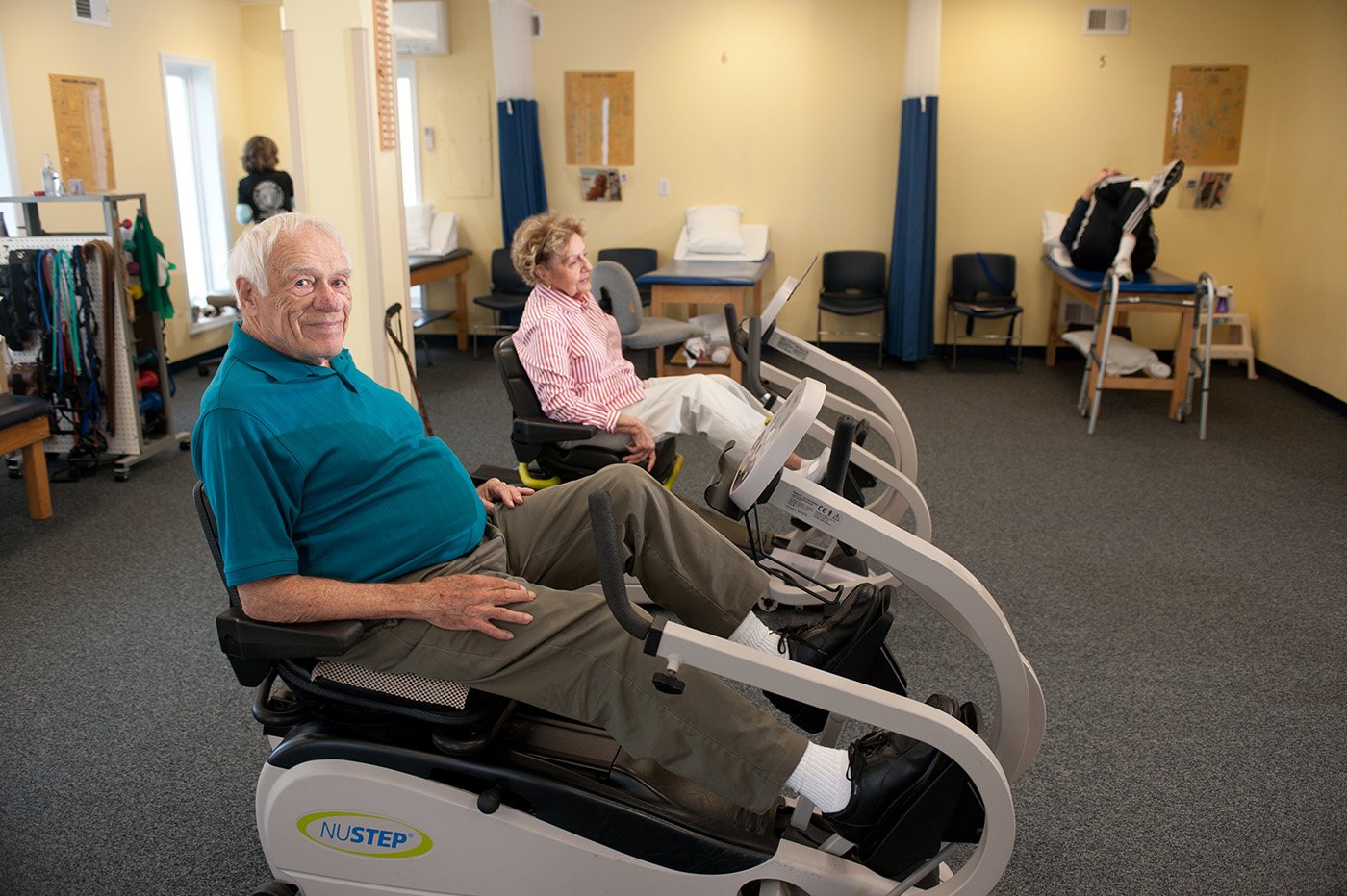 two patients on a NUSTEP machine