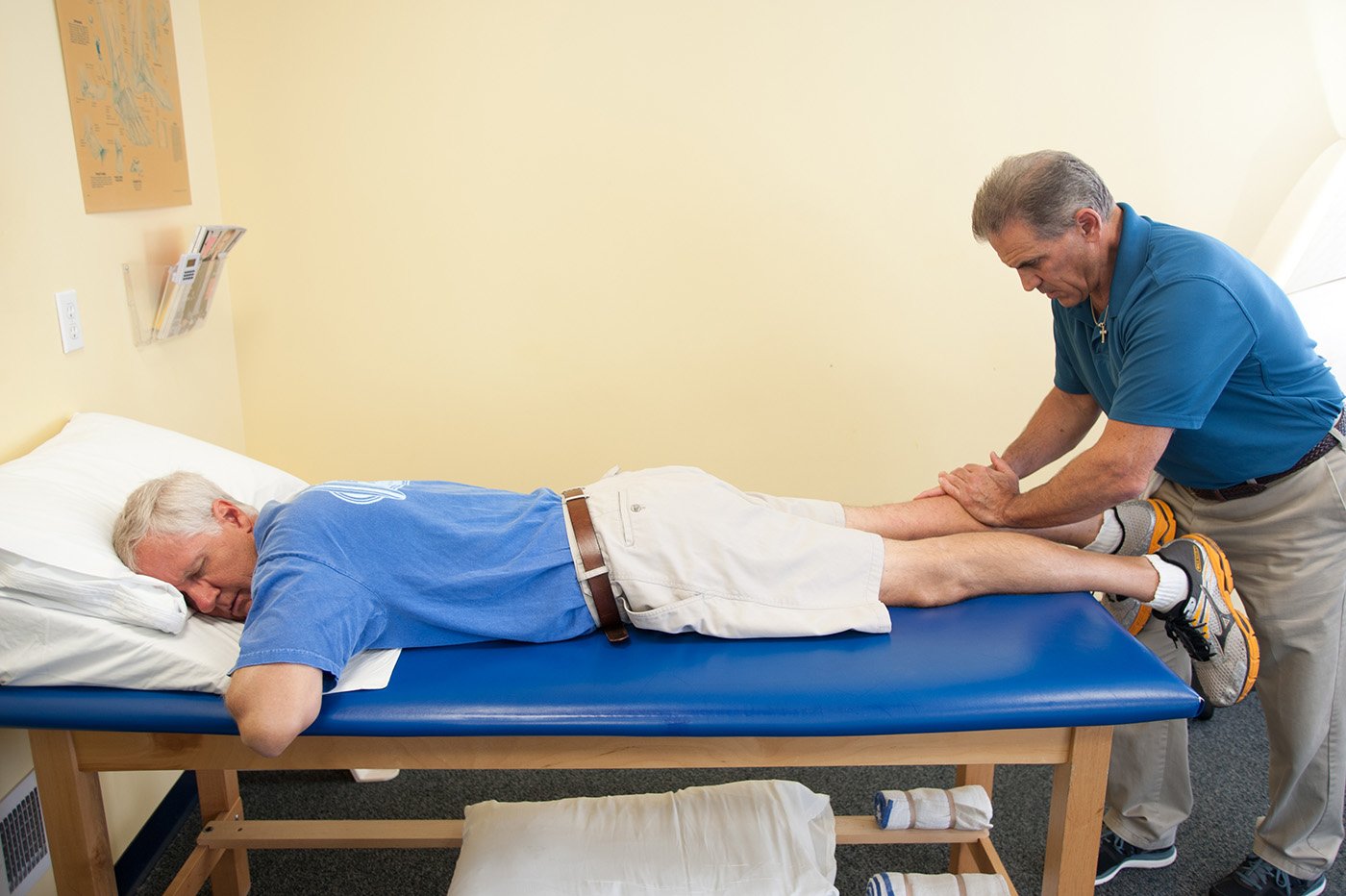 therapist massaging patients calf