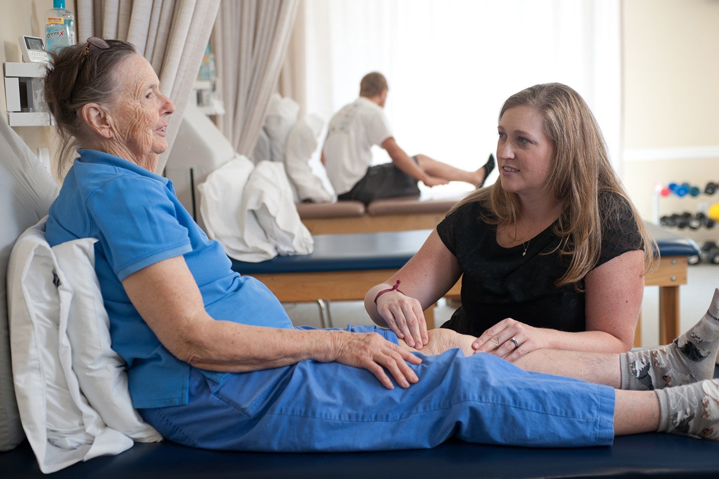 therapist massaging patients knee