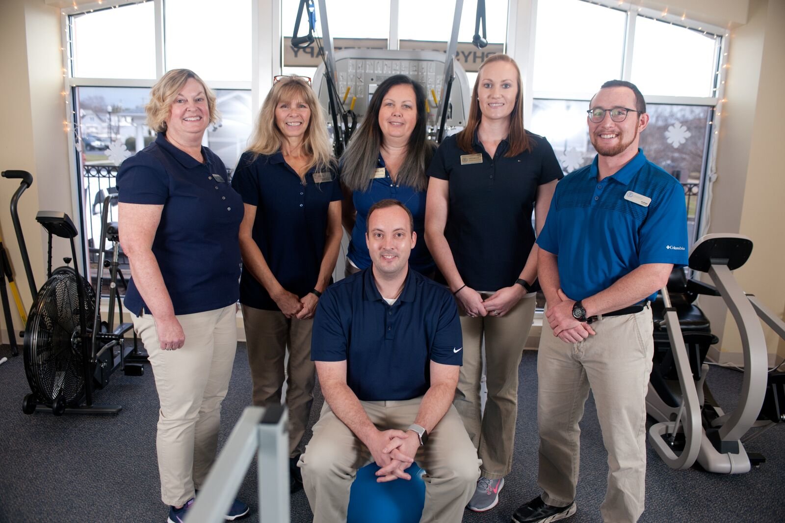 Milton physical therapy team Milton physical therapy team standing in front of therapy and exercise equipment