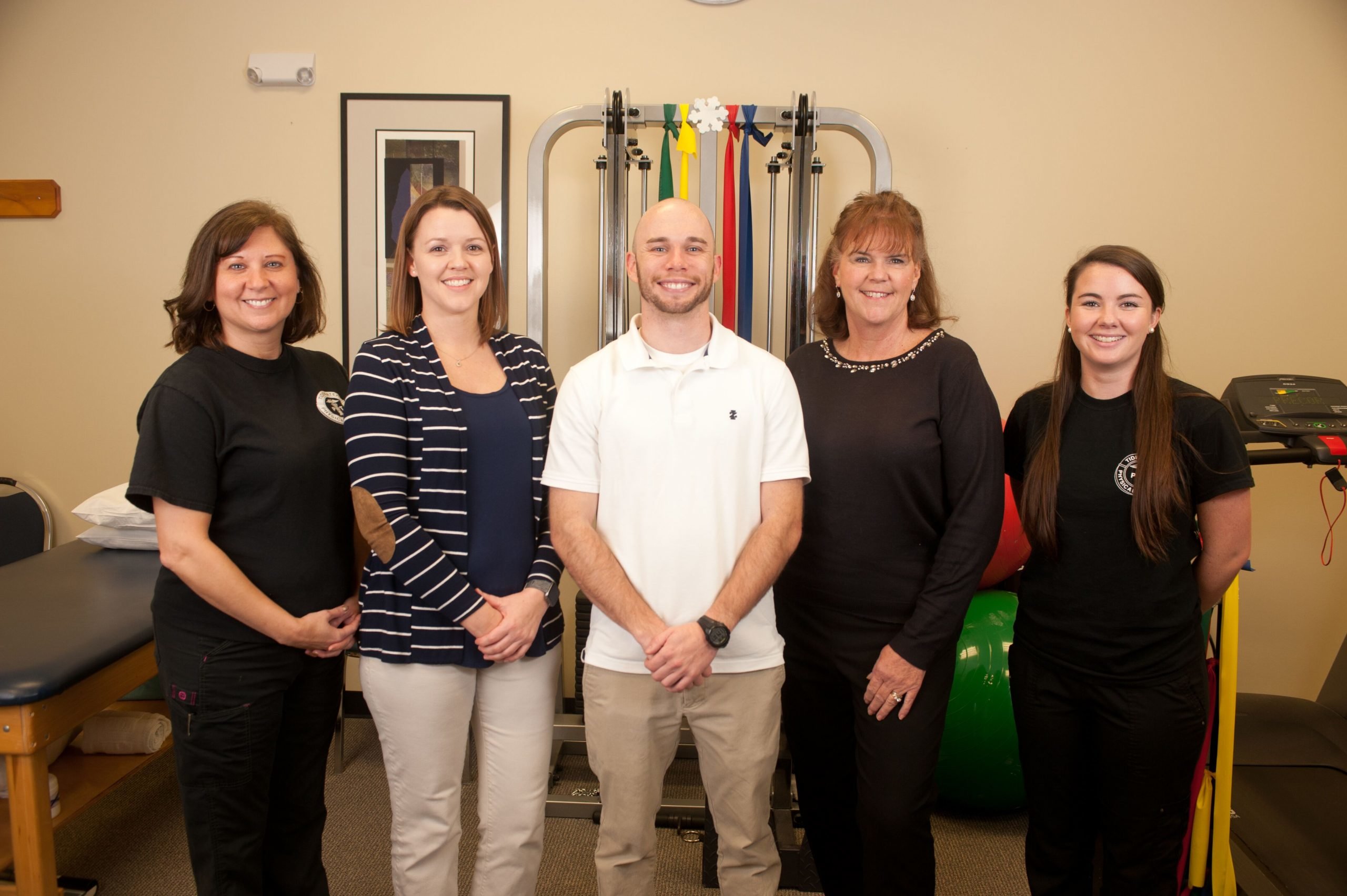 Chester physical therapy team Chester physical therapy team standing in front of exercise equipment