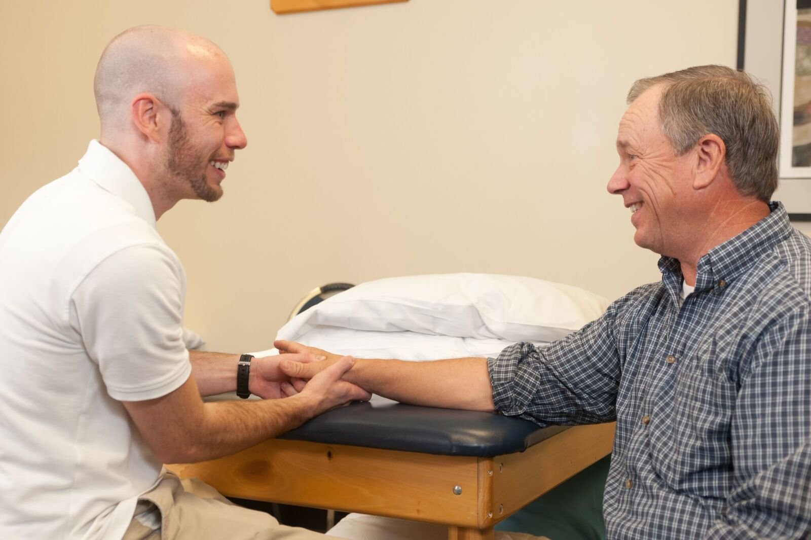 physical therapist Brian assisting with a patient's wrist