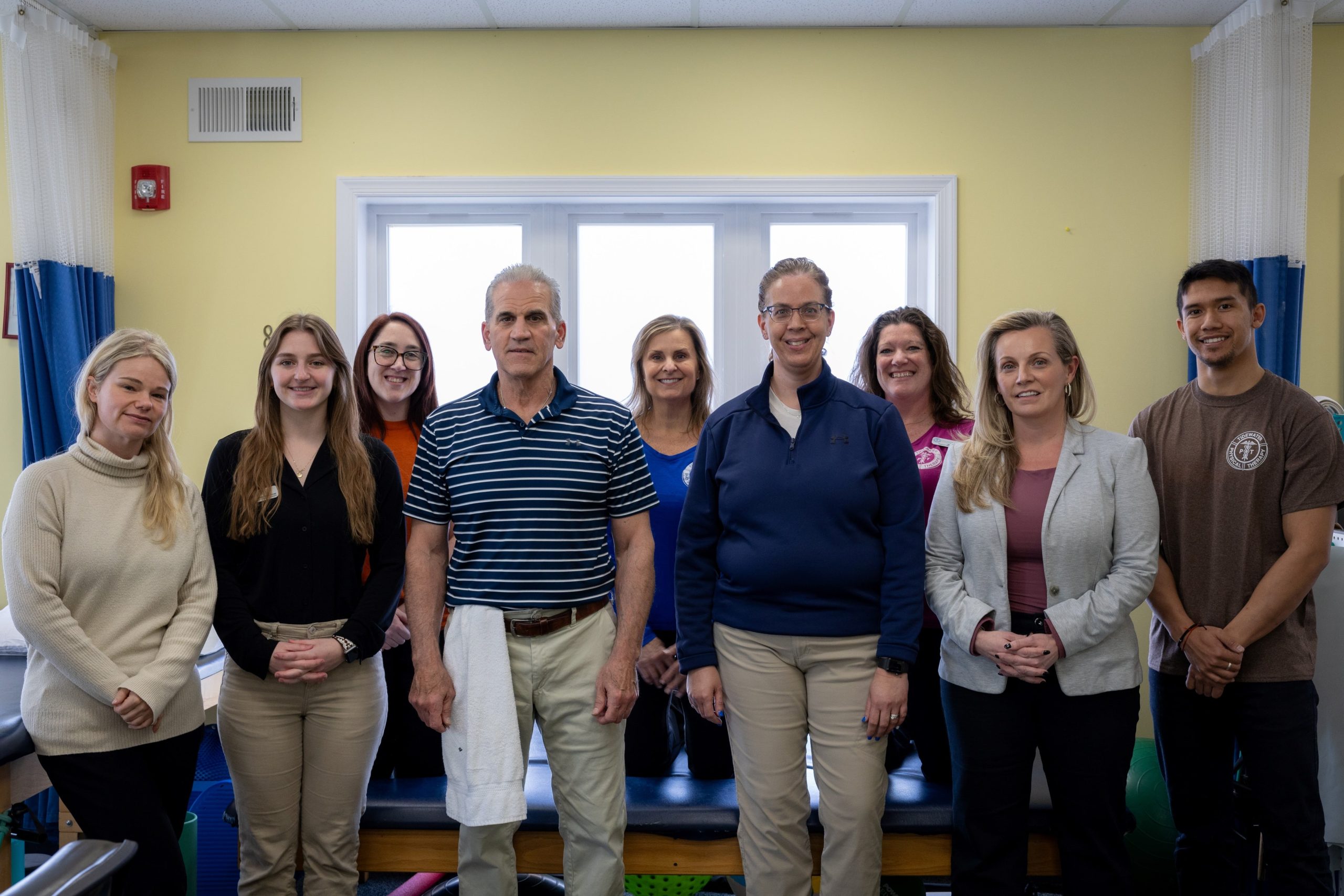 Staff standing all together at the Tidewater physical therapy office
